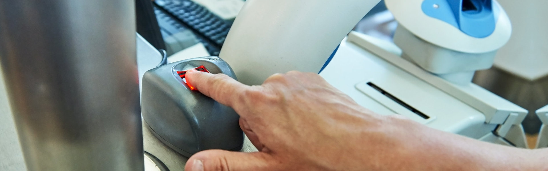 Man scanning fingerprint in an office